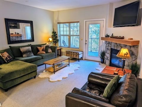 Living room with smart TV and gas fireplace.
