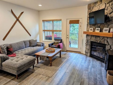 Cozy living room area with a gas fireplace and views looking towards the Mt. Hood National Forest