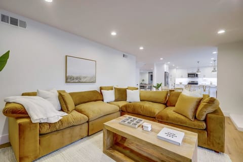 Bright open living room w/ plush seating, clean lines & easy flow into the kitchen for relaxed group hangouts.