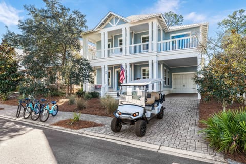 "Blue Peach" a beautiful new home, 1/2 mile from the beach, with a 6 seat golf cart, 4 bicycles, and heated pool access in a gated community.