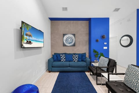 Relax in your stylish living space with modern décor and a pop of bold blue. The cozy seating and clean design create the perfect spot to unwind after your adventures.