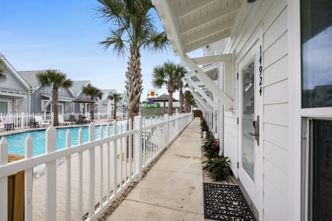 Walk along the covered walkway to your room, with palms swaying overhead and the pool just steps from your door.
