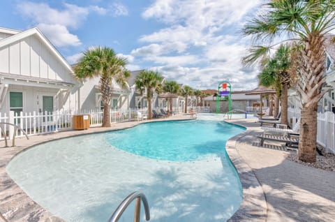 Dive into your private oasis! This sparkling pool offers the perfect escape, surrounded by swaying palms and comfortable loungers for endless relaxation.