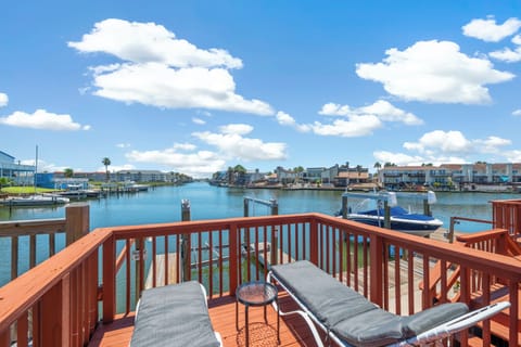 Stretch out on your private waterfront deck and soak in the peaceful canal views, where boats drift by and palm trees line the horizon—your perfect spot to unwind.