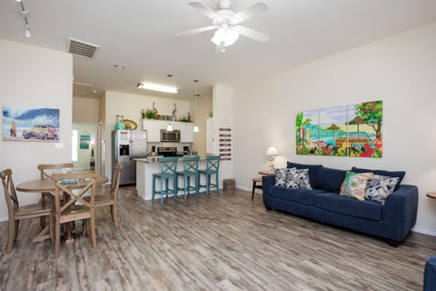 Relax in your bright, open-concept space with tropical artwork, comfy seating, and a fully equipped kitchen.