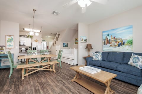 Relax in your coastal-themed living space where beach artwork and nautical touches create the perfect vacation vibe for your getaway.
