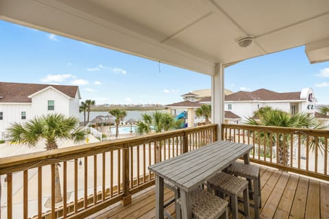 Sip your morning coffee on this covered deck while enjoying waterfront views and coastal breezes through tropical palms.
