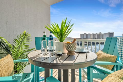 Your private waterfront balcony with tropical plants where you can sip morning coffee while watching boats glide across the sparkling water below.