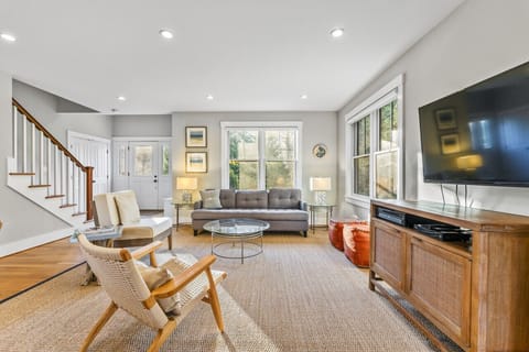 The living room offers a serene ambiance, enhanced by an abundance of natural light pouring in from the outside.