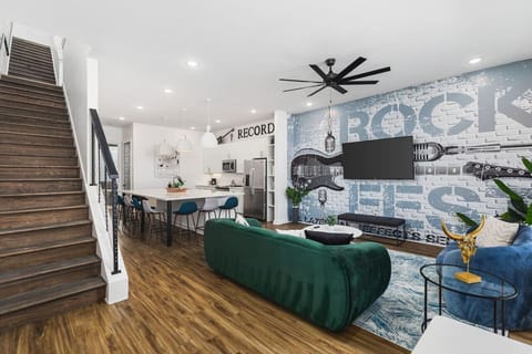 Living room with two comfy couches, a ceiling fan, and a Smart TV with all the streaming apps.