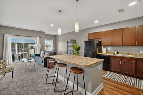 Open-concept living meets functionality with a full kitchen, bar seating for three, and cozy living room flow. Whether cooking, entertaining, or relaxing, this space blends comfort with conven