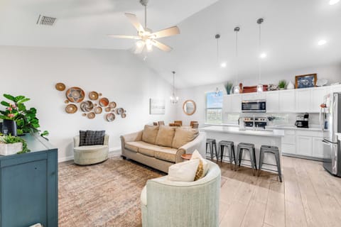 Sink into plush seating in your open-concept living space, where modern kitchen amenities and cozy lounge areas create the perfect home base.