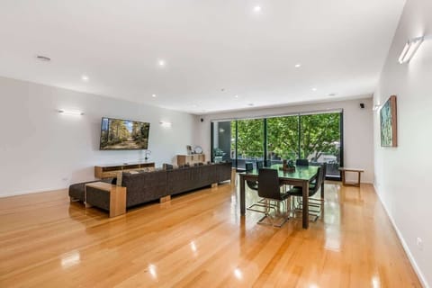 Open plan living and dining room with ample seating.