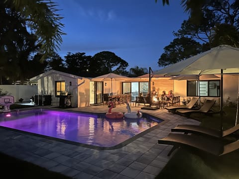 Resort-style pool and backyard including 55" outdoor TV, fire pit and more.