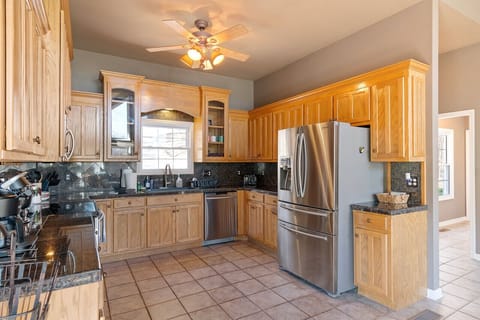 Fully stocked kitchen with plenty of light coming through the bay windows