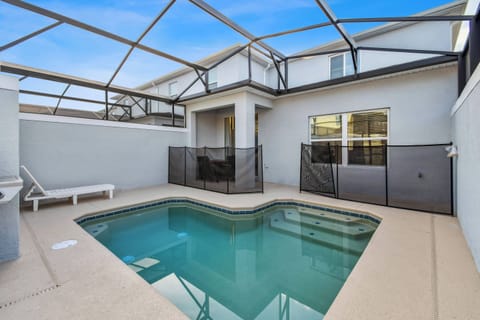 Step into your private oasis with a sparkling pool, enclosed by sleek walls and a protective screen. Bask in the bright atmosphere from the expansive windows, perfect for relaxation or casual gatherings with friends.