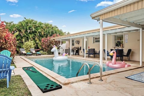 - Sparkling private pool with unicorn and flamingo inflatables  
- Covered patio with seating and grill for outdoor dining  
- Fun backyard escape with mini putting green beside the pool  
