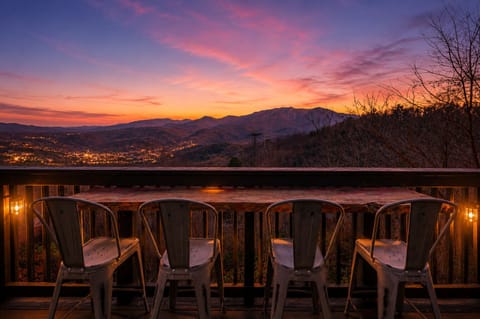 Take in panoramic Smoky Mountain views from the deck, with Mount LeConte stretching across the horizon and the Ober tram visible in the distance.