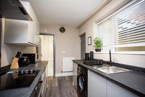 Step into this bright and airy space, where crisp white cabinets provide ample storage for all your cooking essentials, keeping the countertops clutter-free and organized. 