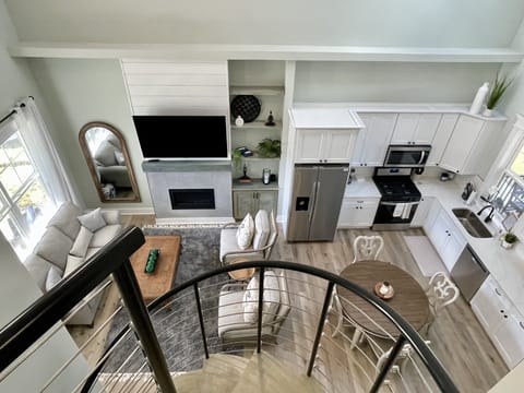 View of open concept living and kitchen space from loft