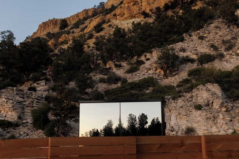 Exterior view of the Mirror House with private outdoor seating, BBQ grill, fire pit, and peaceful Southern Utah views.