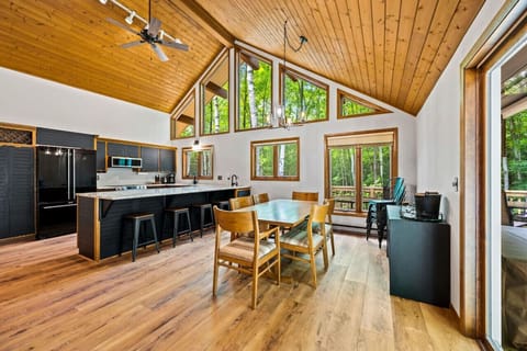 Dining Area: Modern design meets nature in this sunlit dining space with forest views!