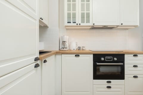 Another perspective of the kitchen with ample counter space and built-in appliances.