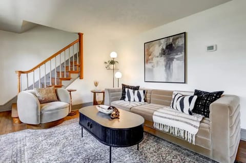 Living room features full size sofa and a comfy swivel chair