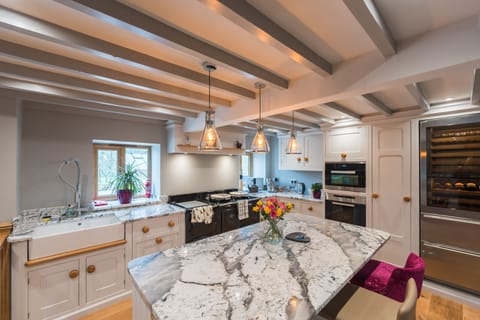 kitchen with Aga, breakfast bar seating, electric oven. microwave and wine cooler