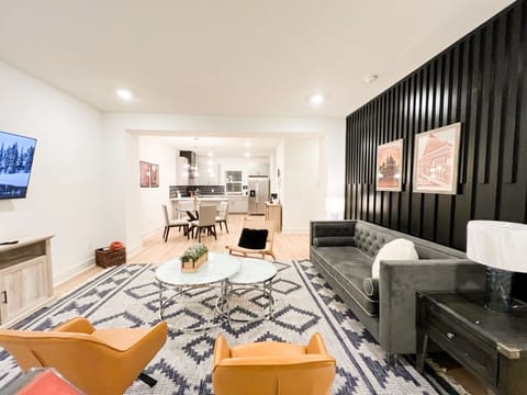 OPEN FLOOR PLAN LIVING ROOM – Step into this stylish, open-concept living and dining area, complete with modern furnishings, a plush sofa, and a 52" flat-screen TV,  ideal for a comfortable and inviting stay in Nashville!