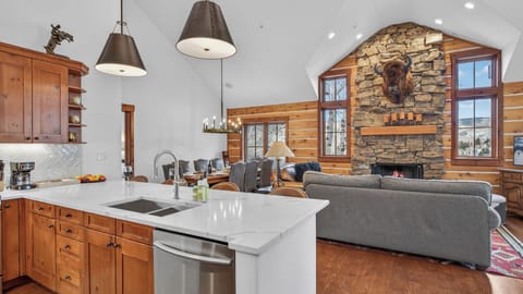 Your open-concept haven blends rustic charm with modern luxury, featuring a gourmet kitchen island and cozy stone fireplace.