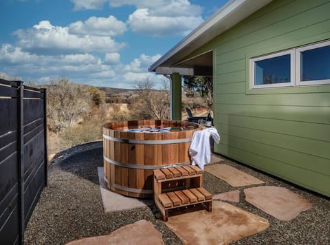 Dive into relaxation in our Northern Lights Cedar hot tub, with Oak Creek's gentle flow and House Mountain's grandeur as your backdrop. It's not just a soak; it's an escape!