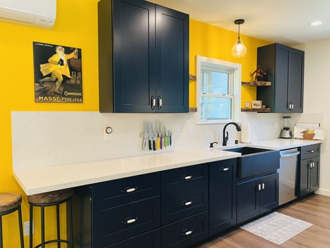 Follow the yellow wall to the modern and bright kitchen.