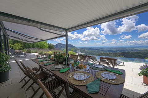 Outdoor dining. Main terrace is shaded by electric awnings. Views to Africa