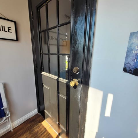 Front door at the top of the stairs.