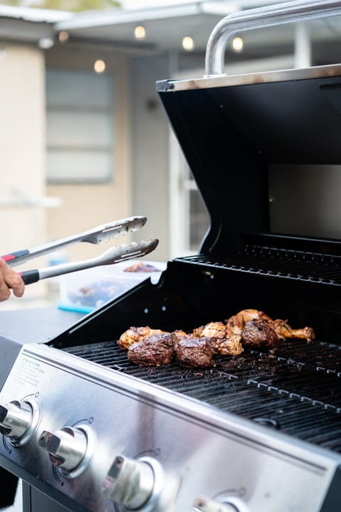 A gas grill and propane tanks are provided for outdoor BBQ fun.