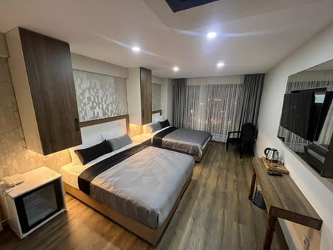 Deluxe Quadruple Room | Free minibar items, desk, soundproofing, iron/ironing board