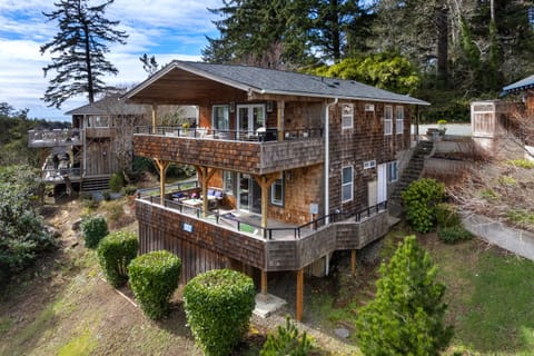 Double decks. Upper with dining table, BBQ, Fire table, Outdoor furniture. Lower with Outdoor furniture, Corn hold, Adirondack chairs