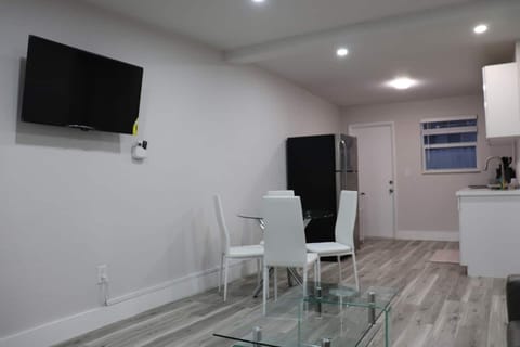 Dining area equipped with a white table and chairs.