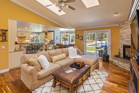 Living room looking at dining nook, kitchen, slider to back yard