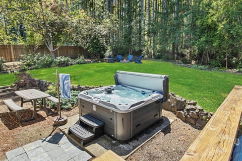 Six-person hot tub and fire pit in the spacious back yard.
