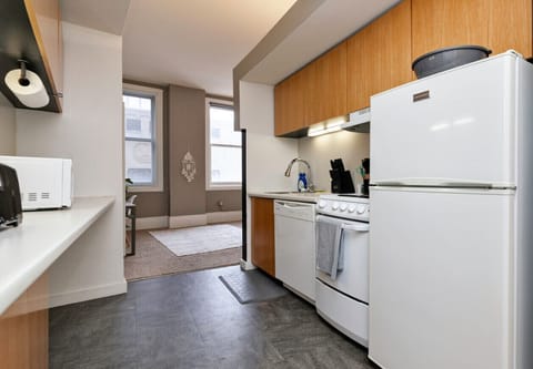 Kitchen in Studio w/ Dishwasher, Stove/Oven & Full sized Fridge