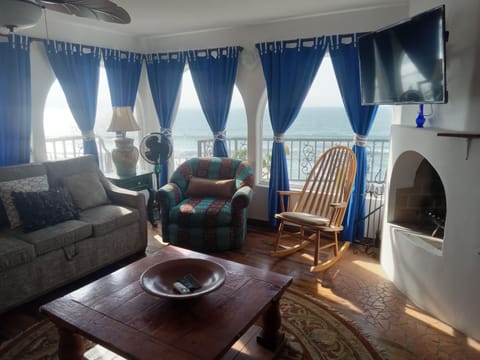 Living room with fireplace and ocean view