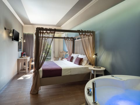 Deluxe Room with Balcony and Hot Tub | 1 bedroom, down comforters, in-room safe, individually decorated