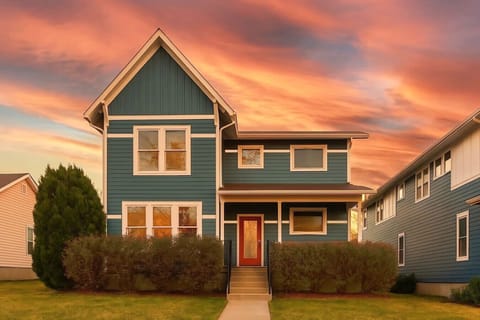 The striking teal and gray exterior glows at sunset, announcing this modern Nashville home from the street.