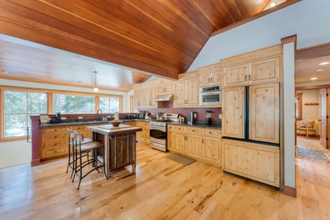 Spacious kitchen is full equipped and features modern appliances.