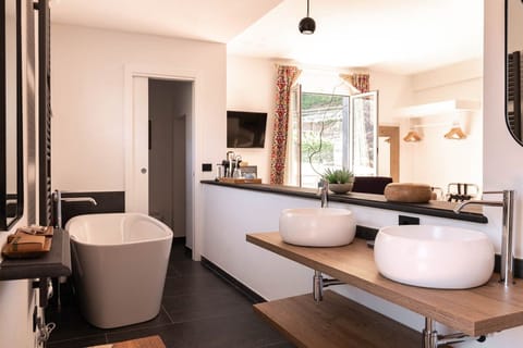 Suite, 1 Bedroom | Bathroom | Rainfall showerhead, hair dryer, bathrobes, slippers