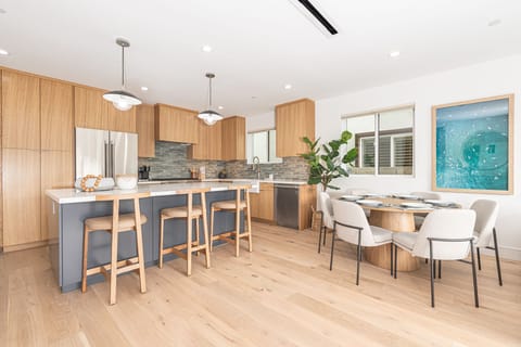 Our open-concept kitchen is perfect for entertaining, featuring a central island with barstool seating and a dining table that accommodates up to 6 guests.
                