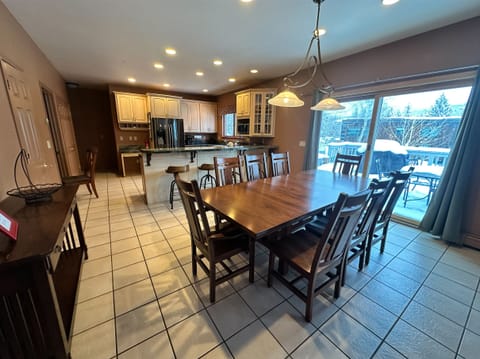 Gather your group around this spacious dining table where warm conversations flow as easily as morning coffee in your fully-equipped kitchen.