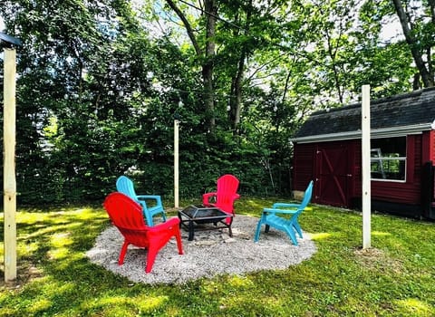 Backyard fire pit with solar string lighting and privacy fencing. 